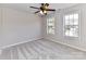 Bedroom with ceiling fan and two windows at 7780 Orchard Park Cir, Harrisburg, NC 28075