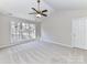 Spacious bedroom with ceiling fan and large window at 7780 Orchard Park Cir, Harrisburg, NC 28075