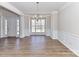 Bright dining room with hardwood floors and a large window at 7780 Orchard Park Cir, Harrisburg, NC 28075