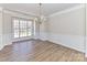 Bright dining room with hardwood floors and wainscoting at 7780 Orchard Park Cir, Harrisburg, NC 28075