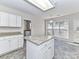 Kitchen with white cabinets, granite countertops and island at 7780 Orchard Park Cir, Harrisburg, NC 28075