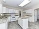 Kitchen with white cabinets, granite countertops and island at 7780 Orchard Park Cir, Harrisburg, NC 28075