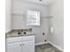 Laundry room with window and granite countertop at 7780 Orchard Park Cir, Harrisburg, NC 28075