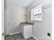 Laundry room with utility sink and built-in shelving at 7780 Orchard Park Cir, Harrisburg, NC 28075