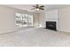 Living room with carpet, fireplace, and large window at 7780 Orchard Park Cir, Harrisburg, NC 28075