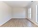 Simple living room with hardwood floors and a large window at 7780 Orchard Park Cir, Harrisburg, NC 28075