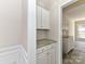 Built-in pantry with granite countertop and white cabinets at 7780 Orchard Park Cir, Harrisburg, NC 28075