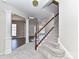 Elegant staircase with wood railing and carpet at 7780 Orchard Park Cir, Harrisburg, NC 28075