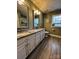 Elegant bathroom with double vanity, granite countertops, and a tiled shower at 7925 Tottenham Dr, Harrisburg, NC 28075