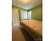 Well-lit bedroom with double doors and a patterned comforter at 7925 Tottenham Dr, Harrisburg, NC 28075