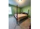 Charming bedroom with a four-poster bed and green walls at 7925 Tottenham Dr, Harrisburg, NC 28075