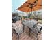 Relaxing deck features a patio dining set and umbrella at 7925 Tottenham Dr, Harrisburg, NC 28075