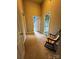 Spacious hallway with light neutral carpeting and rocking chair at 7925 Tottenham Dr, Harrisburg, NC 28075