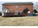 Brick house with large deck, showcasing backyard and landscaping at 7925 Tottenham Dr, Harrisburg, NC 28075