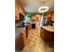 Kitchen boasts oak cabinets, granite countertops, and island at 7925 Tottenham Dr, Harrisburg, NC 28075