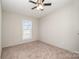 Spacious bedroom featuring a ceiling fan and large window at 820 Bethesda Rd, Statesville, NC 28677