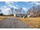 Manufactured home with gravel driveway and a carport at 820 Bethesda Rd, Statesville, NC 28677