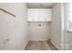 Bright laundry room with upper cabinets and vinyl flooring at 820 Bethesda Rd, Statesville, NC 28677