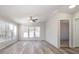 Sunlit living room with vinyl flooring and multiple windows at 820 Bethesda Rd, Statesville, NC 28677