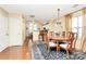 Bright dining room with hardwood floors and a charming table set for a meal at 8927 Bryant Field Cir, Charlotte, NC 28277