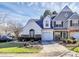 Two-story townhome with gray and white siding, attached garage, and landscaped yard at 8927 Bryant Field Cir, Charlotte, NC 28277