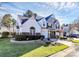 Two-story townhome with gray and white siding, landscaping, and driveway at 8927 Bryant Field Cir, Charlotte, NC 28277