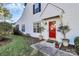 Red front door with sidelights and two potted trees at 8927 Bryant Field Cir, Charlotte, NC 28277