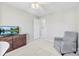 Bedroom with a comfortable armchair and a large TV at 9112 Meadowmont View Dr, Charlotte, NC 28269