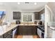 Kitchen with granite counters and dark brown cabinets at 9112 Meadowmont View Dr, Charlotte, NC 28269