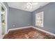 Bedroom with hardwood floor, large window, and ceiling fan at 9261 Meadow Vista Rd, Charlotte, NC 28213