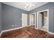 Bright bedroom featuring hardwood floors and mirrored closet doors at 9261 Meadow Vista Rd, Charlotte, NC 28213