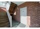 Brick building exterior, white door, wooden stairs at 9261 Meadow Vista Rd, Charlotte, NC 28213