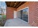 Brick patio with sliding glass doors leading to the backyard at 9261 Meadow Vista Rd, Charlotte, NC 28213