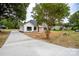 Modern farmhouse exterior with a long driveway at Lot 1 Hoke W St, Landis, NC 28088