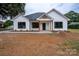 Newly built white house with black windows and a welcoming front porch at Lot 1 Hoke W St, Landis, NC 28088