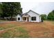 Charming white house with black windows, wooden accents, and a sizable yard at Lot 1 Hoke W St, Landis, NC 28088