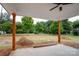 Covered back porch with wooden posts overlooking a large backyard at Lot 1 Sloop St, China Grove, NC 28023