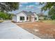 Newly constructed home with white siding, dark windows, and a concrete driveway at Lot 1 Sloop St, China Grove, NC 28023