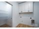 Laundry room with white cabinets, wire shelving, and a water dispenser at Lot 1 Sloop St, China Grove, NC 28023