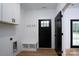 Laundry room with white cabinets, bench, and access to backyard at Lot 1 Sloop St, China Grove, NC 28023