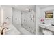 Large bathroom with double vanity, walk-in shower, and marble tile at 10512 Roseberry Ct, Charlotte, NC 28277