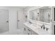 Double vanity bathroom with marble floors and a large mirror at 10512 Roseberry Ct, Charlotte, NC 28277