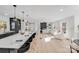 Modern kitchen with dark cabinetry, quartz countertops, and breakfast bar at 10512 Roseberry Ct, Charlotte, NC 28277
