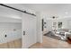 Modern laundry room with sliding barn door and built-in shelving at 10512 Roseberry Ct, Charlotte, NC 28277