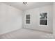 Bright and airy bedroom with neutral carpet and two large windows at 10605 S Hampton Dr, Charlotte, NC 28227