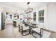 Open concept dining area with glass table and view into the kitchen at 10605 S Hampton Dr, Charlotte, NC 28227