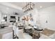 Elegant dining room with a glass table and modern light fixture at 10605 S Hampton Dr, Charlotte, NC 28227