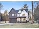 Stunning two-story home boasts a modern farmhouse design, featuring dark brick and white accents at 10605 S Hampton Dr, Charlotte, NC 28227
