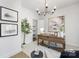 Bright home office features a wooden desk, large art piece, and ample natural light at 10605 S Hampton Dr, Charlotte, NC 28227