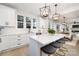 Bright kitchen featuring white cabinets, quartz countertops, and an eat-in island at 10605 S Hampton Dr, Charlotte, NC 28227